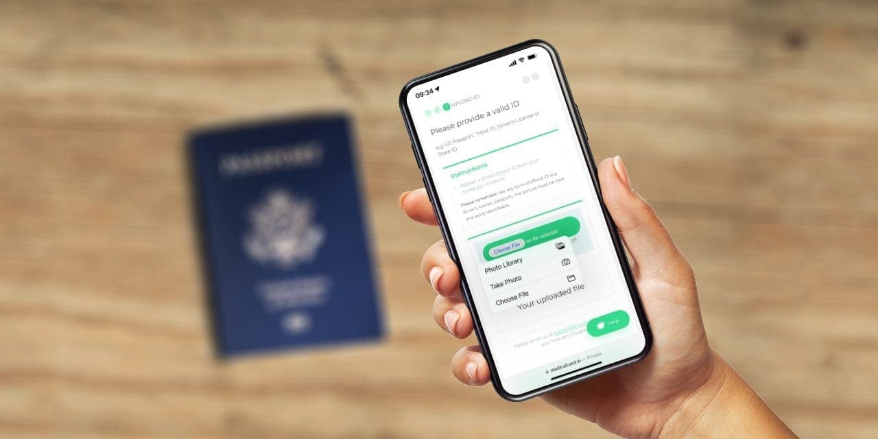 closeup hand holding a phone and a blurred passport